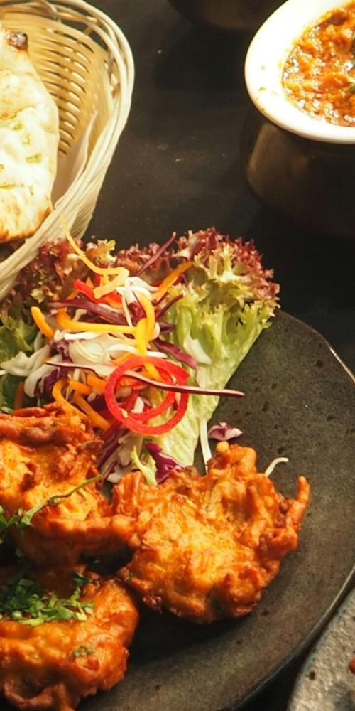 pexels-photo-958546-958546 A delicious Indian food spread featuring curries, naan, and colorful salads, perfect for dinner.